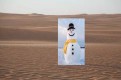 A snowman in a desert  Description automatically generated with medium confidence